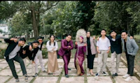 a group of people posing for a picture in a park