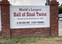 a sign that says world's largest ball of seal twine