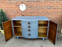 a blue and gold sideboard with two doors