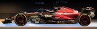 a red and black racing car is on display