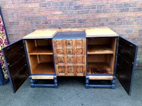 a wooden cabinet with two doors and two drawers