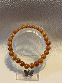 a wooden bracelet on a glass holder
