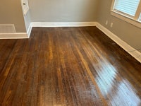 a room with hardwood floors and a window
