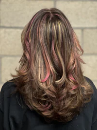 the back of a woman's hair with pink and brown highlights