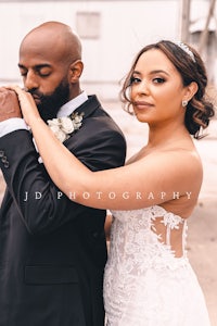 a bride and groom posing for a wedding photo
