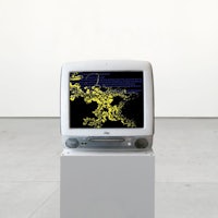 a computer monitor on a pedestal in an empty room