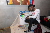 a man is painting on a canvas