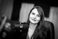 a black and white photo of a woman in front of a microphone