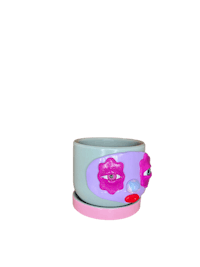 a pink and purple flower pot with a face on it