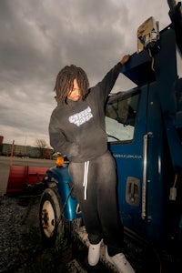 a person leaning on the back of a blue truck