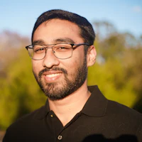 a man wearing glasses and a black shirt