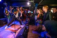 a group of people watching a band perform on stage