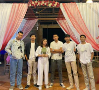 a group of people posing for a picture in front of a stage