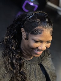 a woman with long hair sitting in a salon