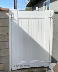 a white fence with a white gate
