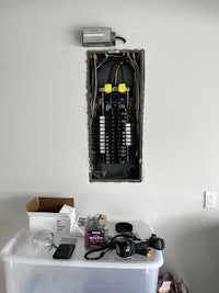 a white box with wires hanging from it