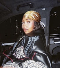 a woman in a leather jacket sitting in a car