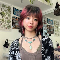 a girl with pink hair and a necklace