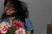 a woman holding a bouquet of flowers