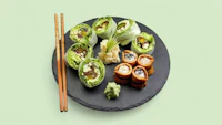 japanese sushi on a plate with chopsticks
