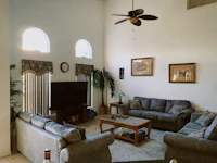 a living room with couches and a tv