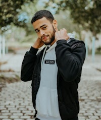 a man wearing a black and white hoodie