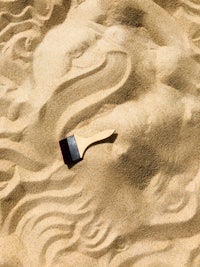 a sand sculpture with a brush in the sand