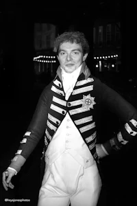 a black and white photo of a man in a costume