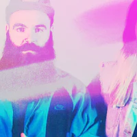 two people with beards standing next to each other