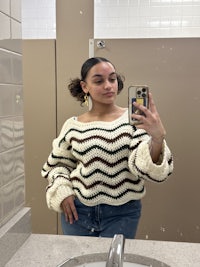 a woman taking a selfie in a bathroom