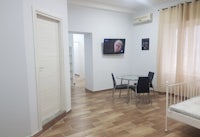 a small room with a bed and a television