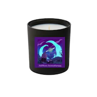 a candle with an image of a cat and a moon on it