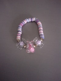 a bracelet with a pink, purple, and white bead