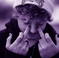 a man with a purple beanie covering his eyes