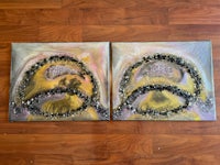 two yellow and black paintings on a wooden floor