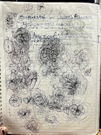 a notebook with a lot of doodles on it