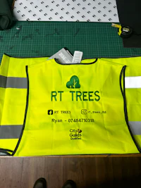 a yellow vest with the words rt trees on it