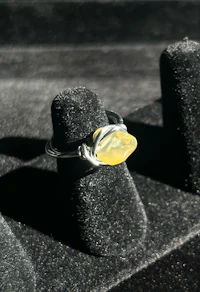 a ring with a yellow stone on it