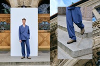a man in a blue suit standing on steps