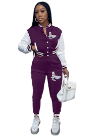 a woman wearing a purple hoodie and a pair of white sneakers