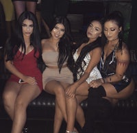 a group of women posing for a photo at a nightclub