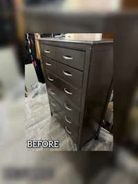 a chest of drawers with paint on it