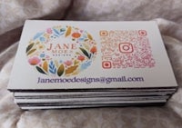 a stack of business cards with a qr code