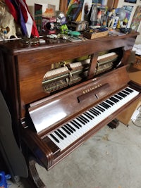 a brown piano is sitting in a garage