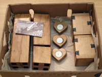 a box containing several wooden boxes and a heart shaped candle