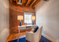 a small room with a desk and a window