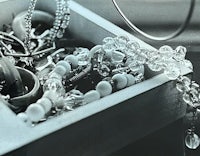 a black and white photograph of jewelry in a box