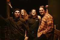 a group of men posing for a picture in a dark room