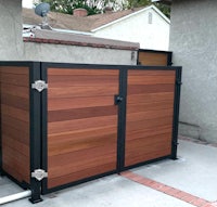 a wooden storage shed with a metal frame