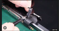 a person is using a pair of pliers to remove the screen from a laptop